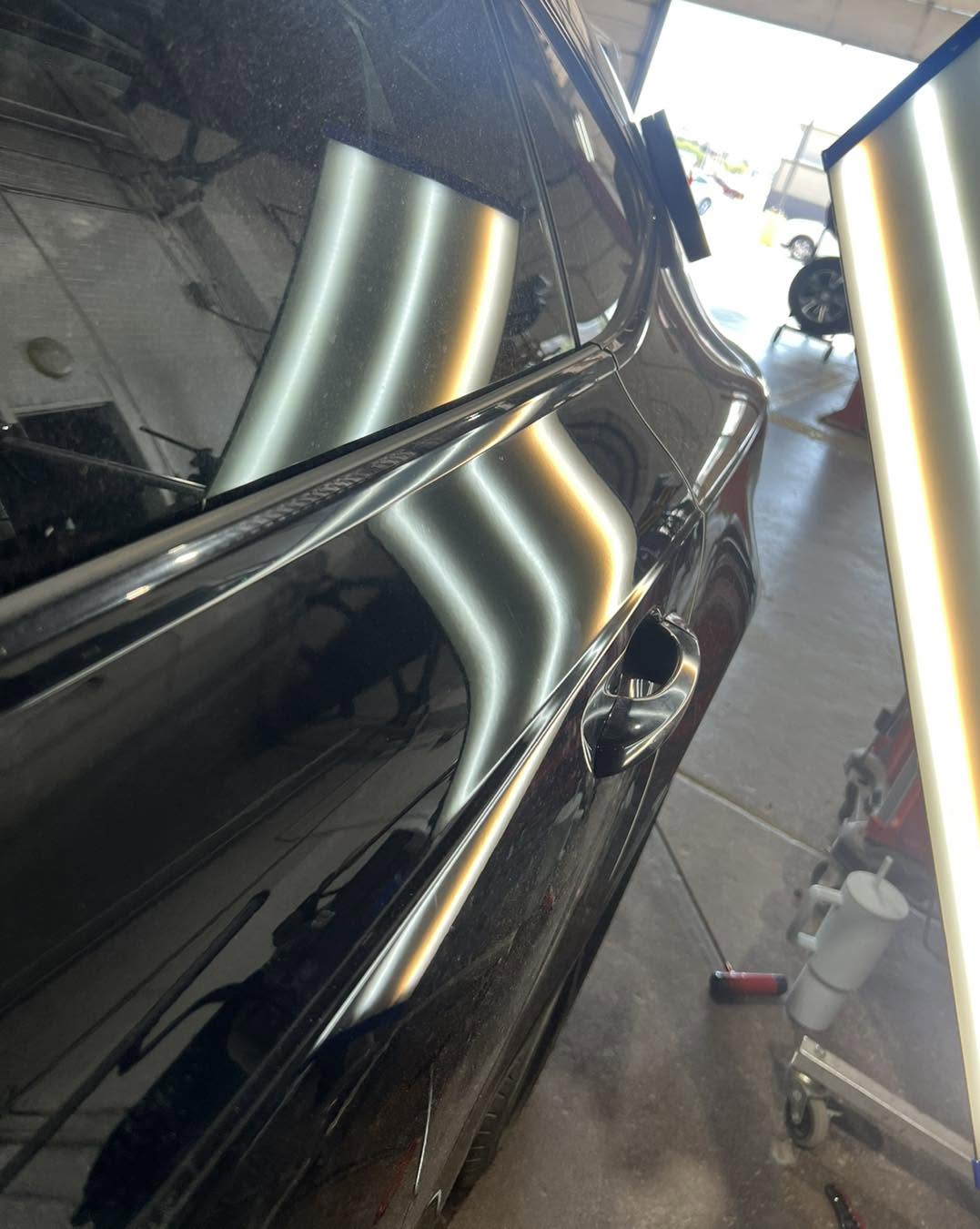 Same Audi door area after repair, with the reflected lines restored