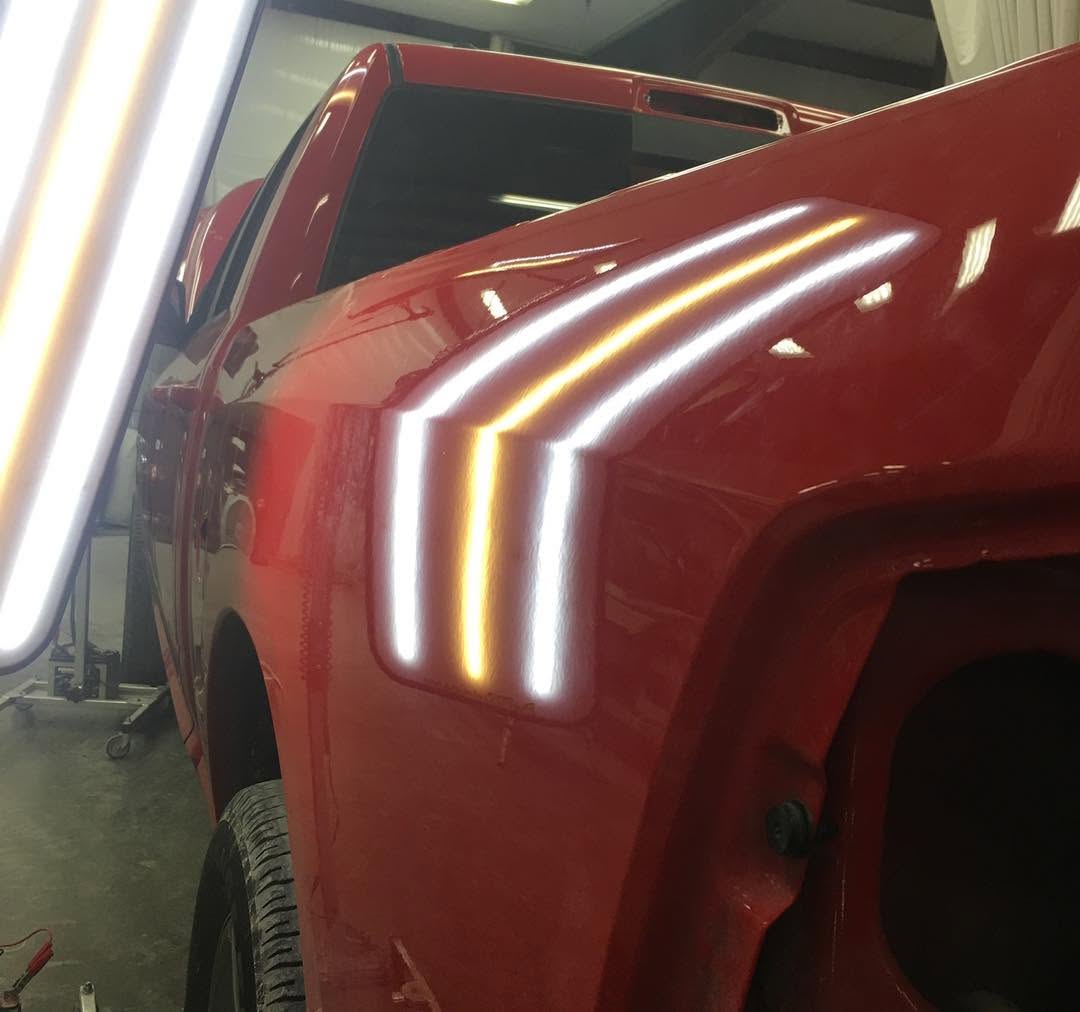 Same Dodge Ram bedside after repair, with smoother reflected light lines
