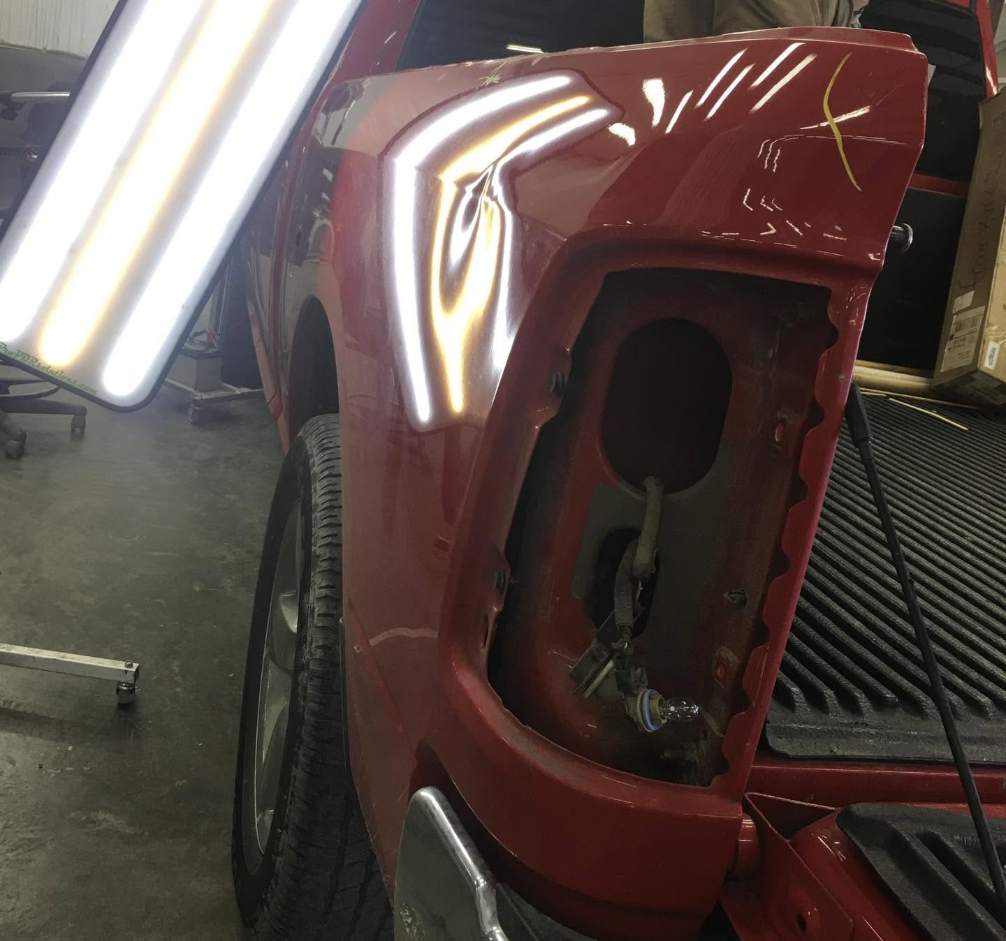 Dodge Ram bedside dent distorting the reflected repair light before repair